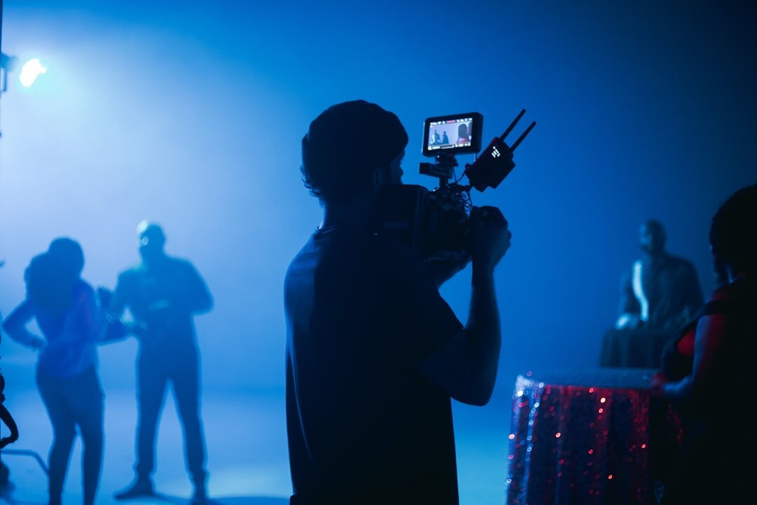Camera operator filming on set with director cues