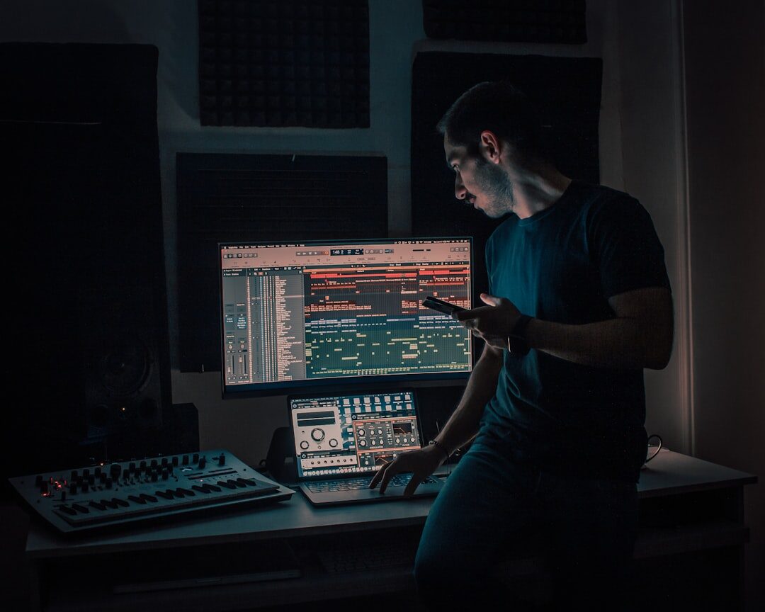 Sound engineer at mixing console in recording studio
